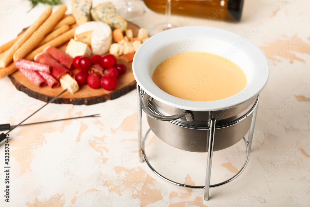 Cheese fondue with snacks on white background