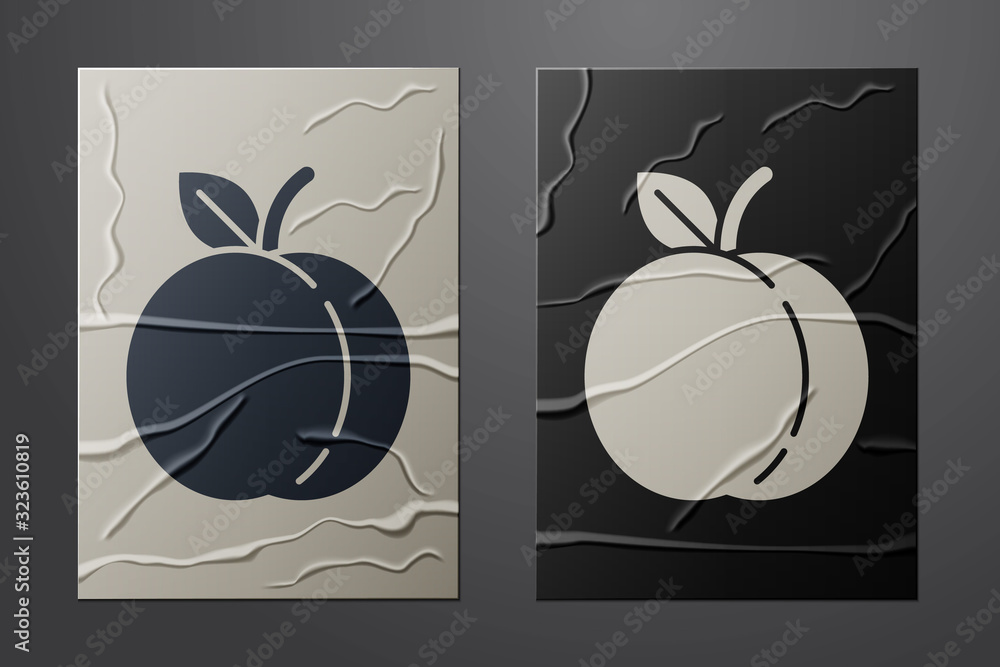 White Peach fruit or nectarine with leaf icon isolated on crumpled paper background. Paper art style