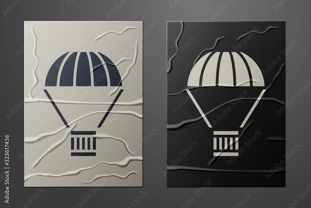 White Box flying on parachute icon isolated on crumpled paper background. Parcel with parachute for 