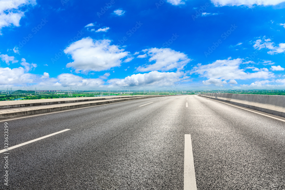 Empty asphalt highway and city suburb skyline on a sunny day in Shanghai.