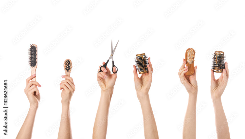 Many hands with hairdressers supplies on white background