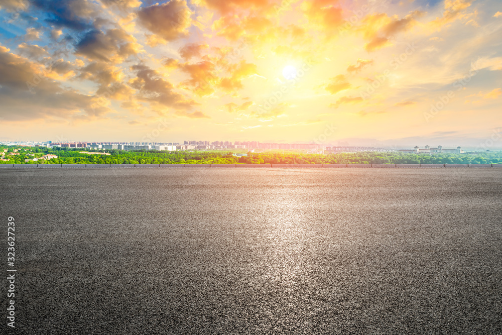 Empty asphalt highway and city suburb skyline in Shanghai at sunset.