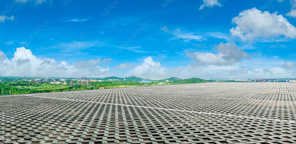 Wide square floor and city suburb skyline on a sunny day in Shanghai,panoramic view.