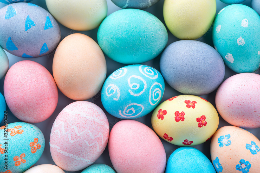 Colorful Easter eggs dyed by colored water with beautiful pattern on a pale blue background, design 