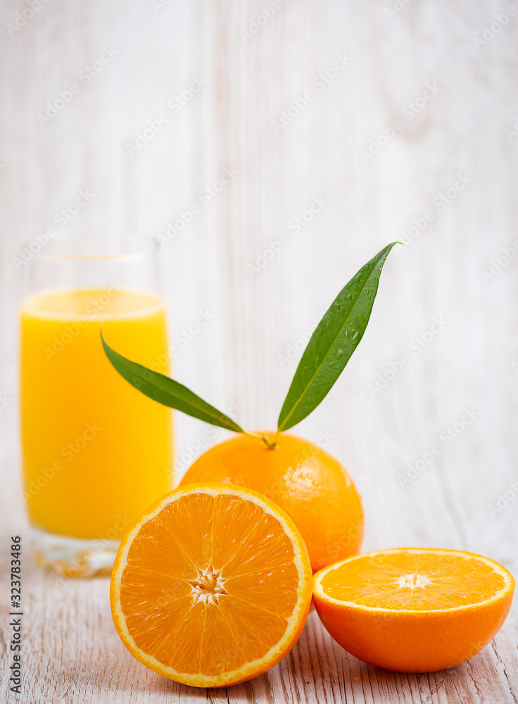 Natural fresh fruit oranges in a wooden background backdrop, half cut oranges, orange juice, vitamin