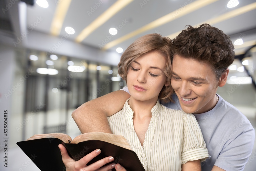 Couple reading Bible book together