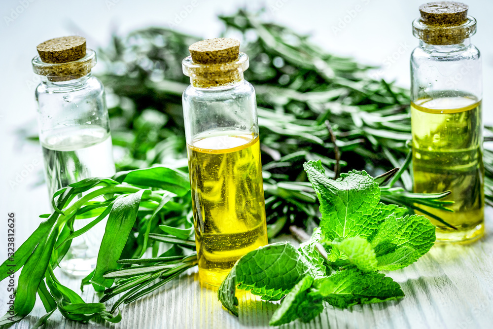 homemade spa with herbal extract in oil on wooden table background