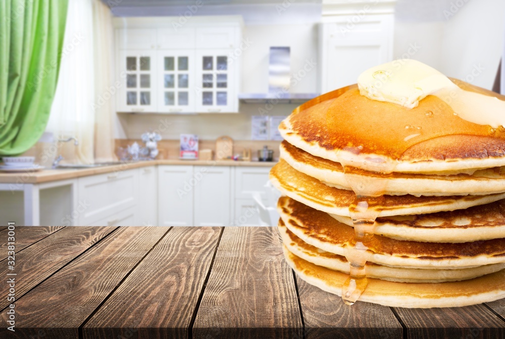 Stack of delicious pancakes on wooden desk