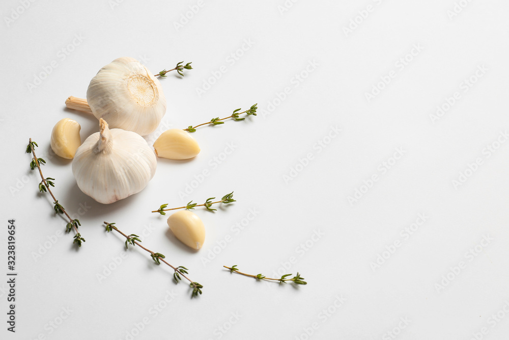 Garlic and herbs on white background