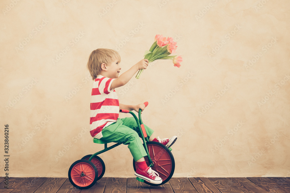 Funny child holding bouquet of flowers