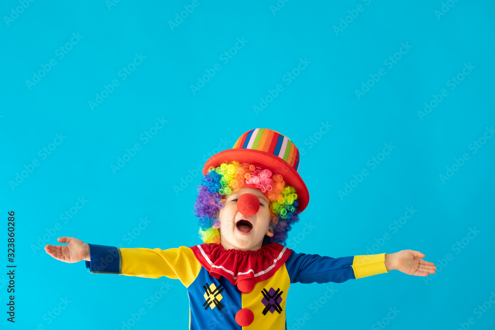 Funny kid clown playing indoor