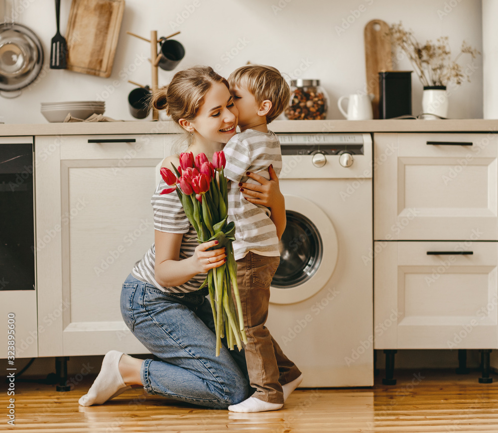 happy mothers day! child son gives flowers for  mother on holiday .