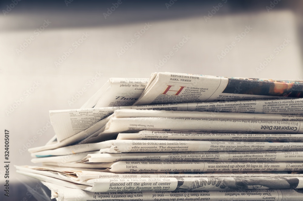 Pile of newspapers stacks on blur background