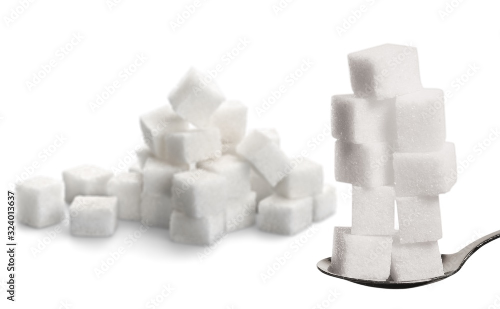 White cubes of sugar on a metal spoon