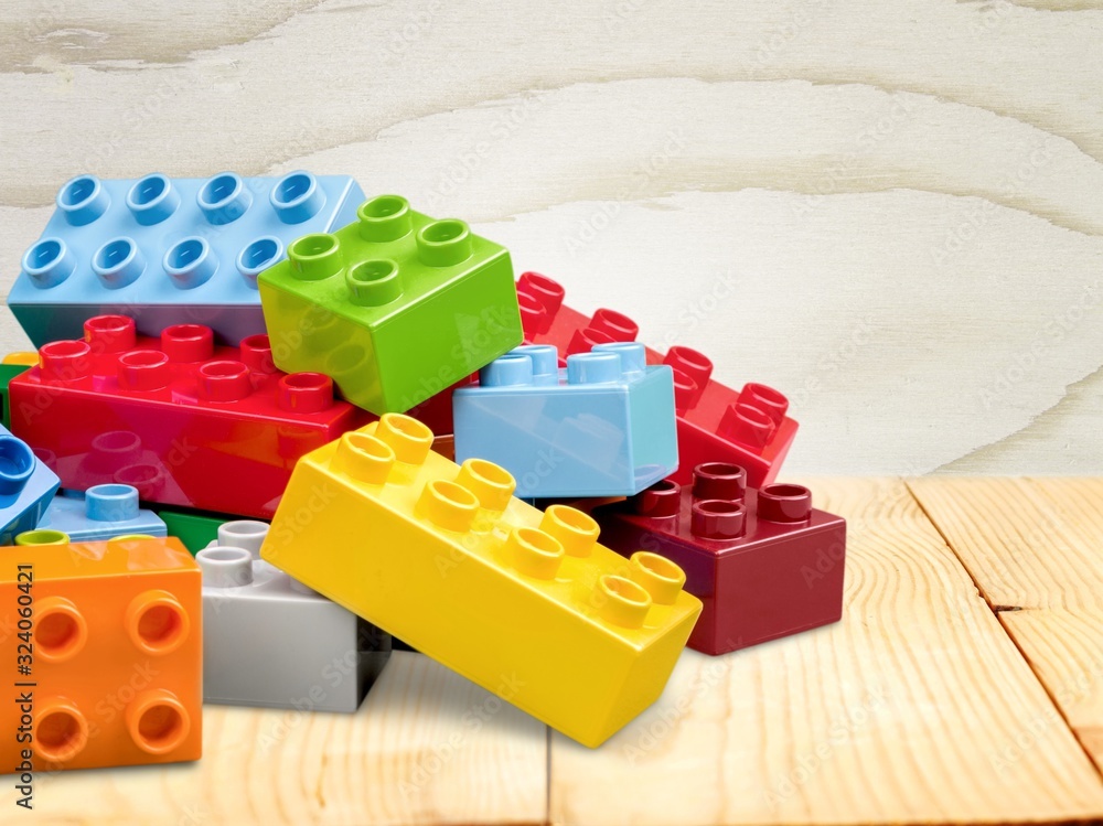 Colorful children building bricks on desk