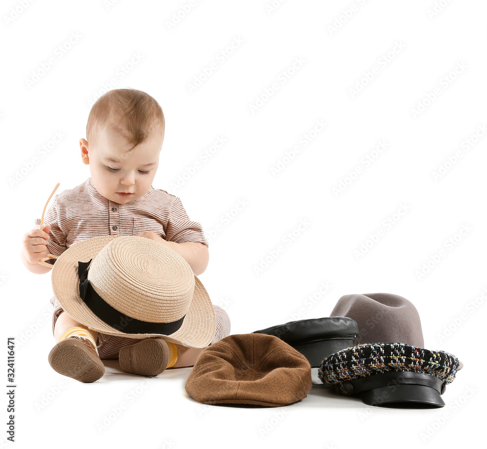 Cute baby with stylish hats on white background