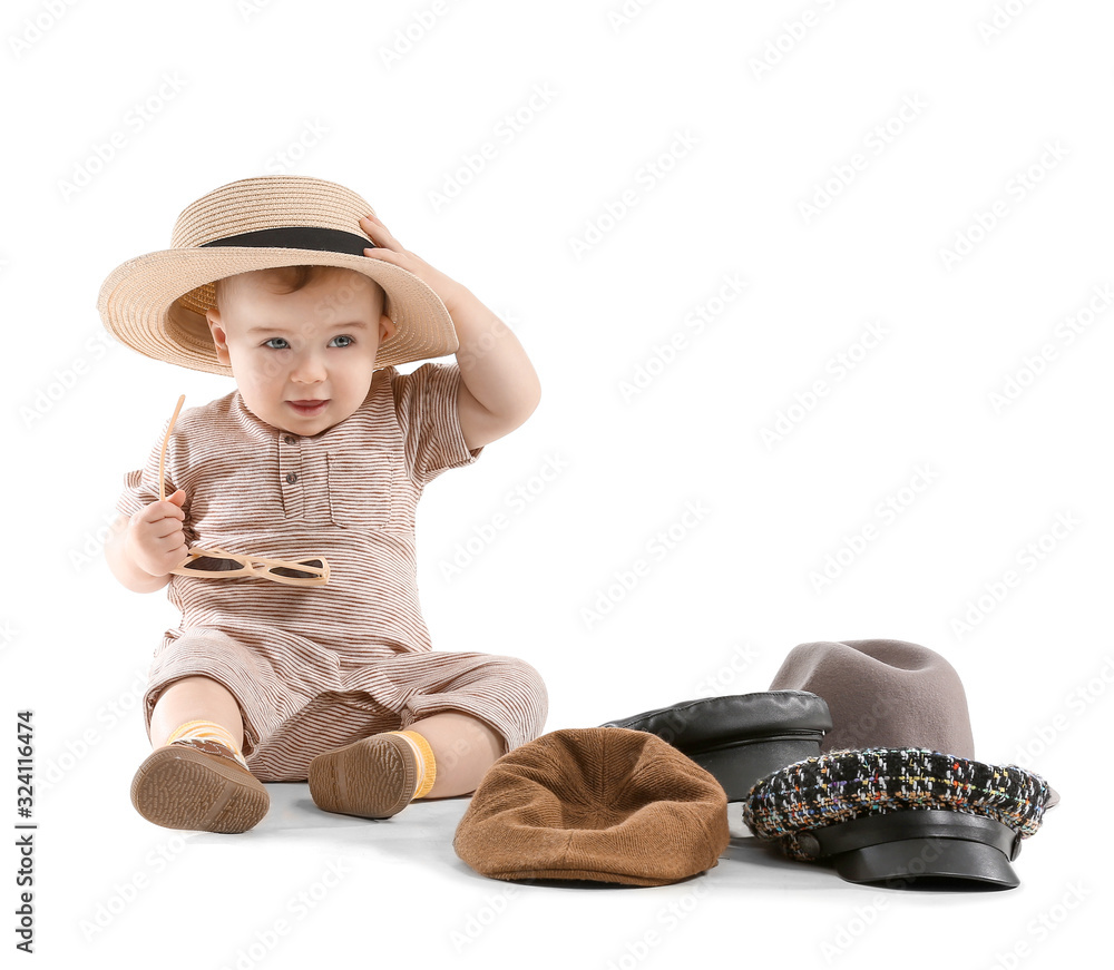 Cute baby with stylish hats on white background