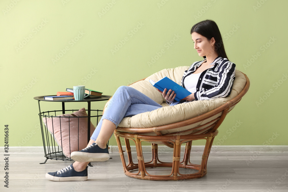 Young woman reading book at home