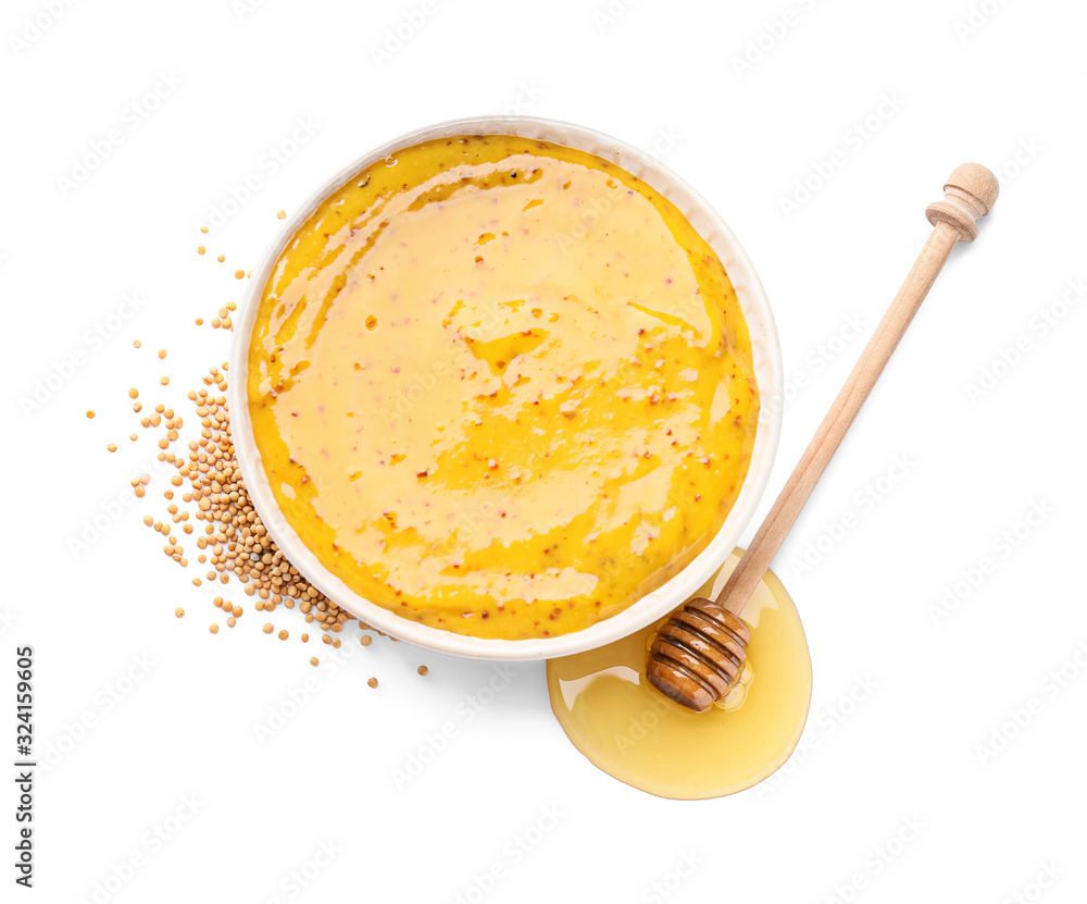 Bowl of tasty honey mustard sauce on white background