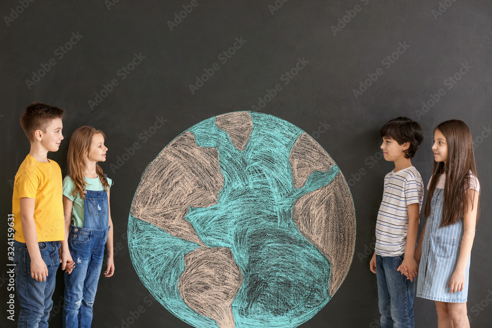 Little children and drawing of planet on dark background. Earth Day celebration