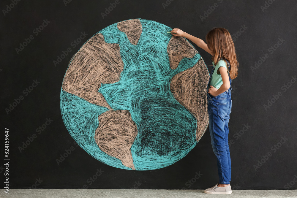 Little girl drawing planet on dark background. Earth Day celebration