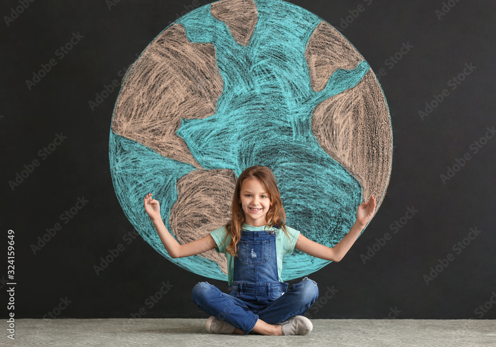 Little girl and drawing of planet on dark background. Earth Day celebration