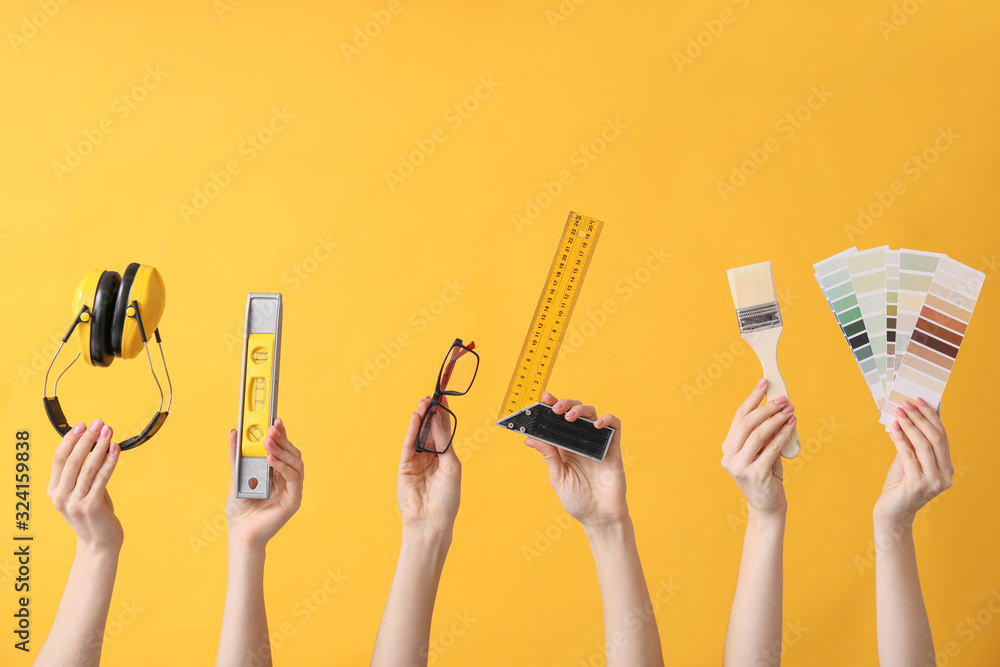 Many hands with architects supplies on color background