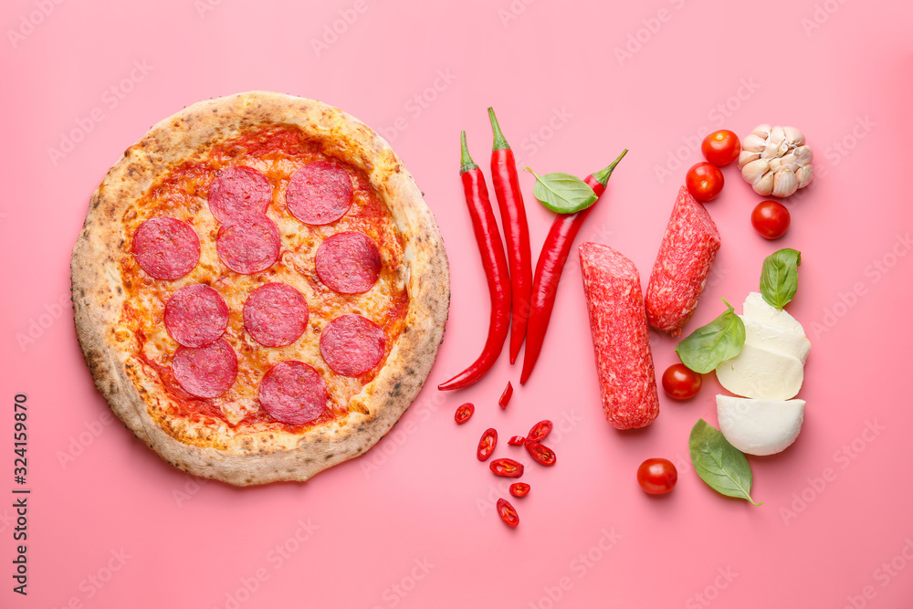 Tasty pizza with ingredients on color background