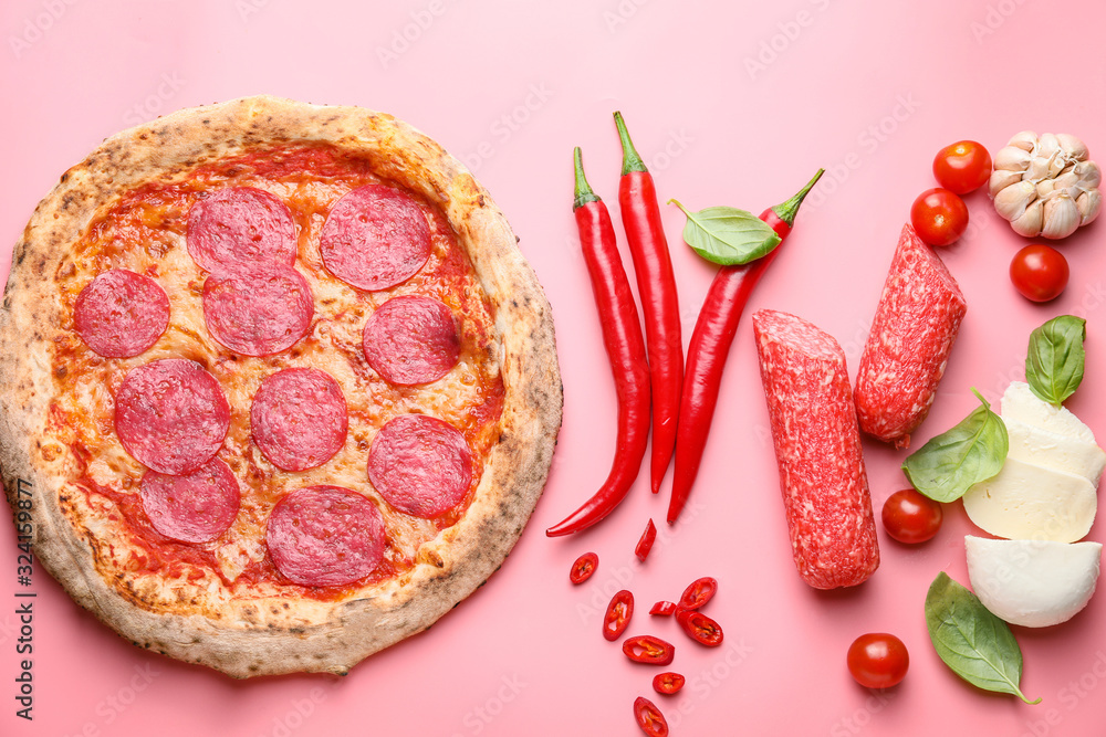 Tasty pizza with ingredients on color background