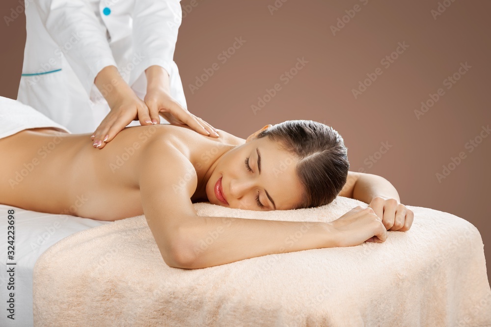 Beautiful young woman relaxing with massage at beauty spa