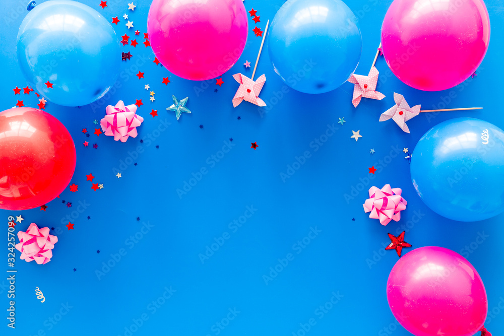 Party concept. Colorful balloons and confetti on blue background top-down frame copy space