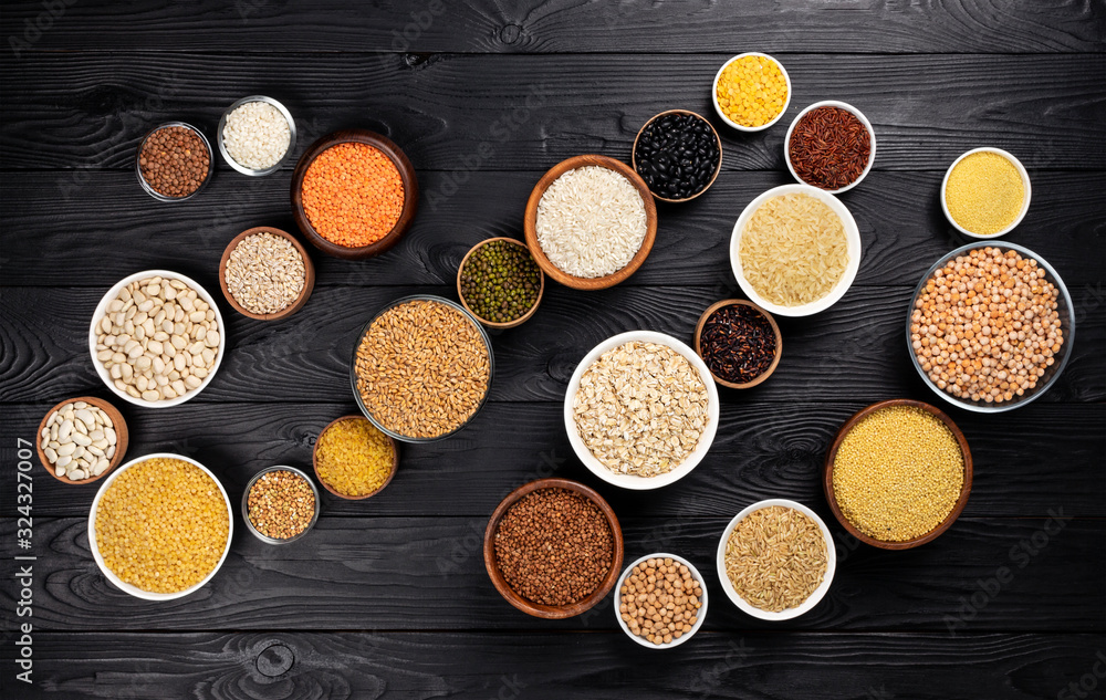 Cereals, grains, seeds and groats black wooden background