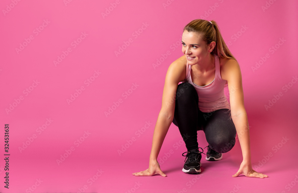 Fit woman on pink background at starting with copy space