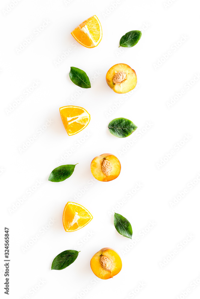 Peach slices and leaves pattern on white background top-down frame copy space