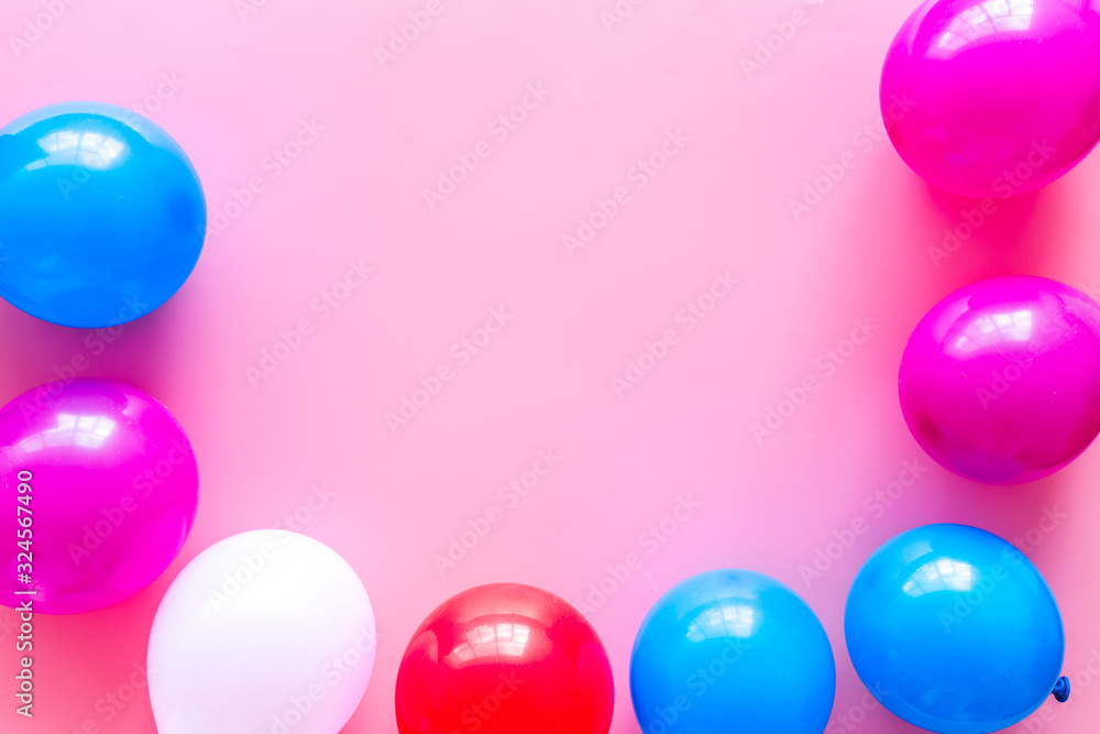 Decorative frame with colorful balloons on pink background top-down frame copy space