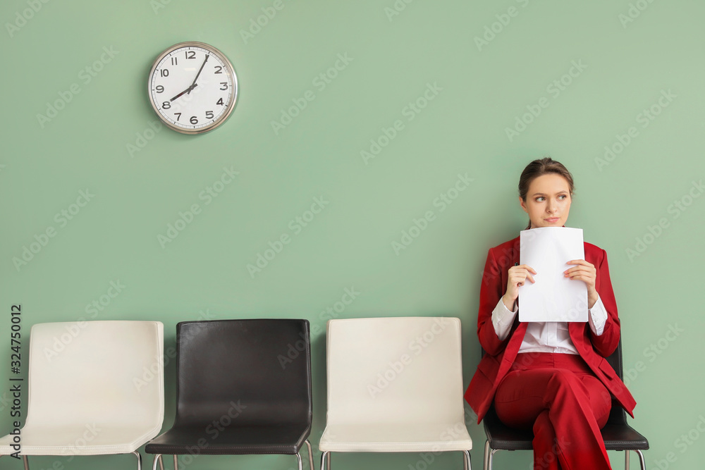 Young woman waiting for job interview indoors