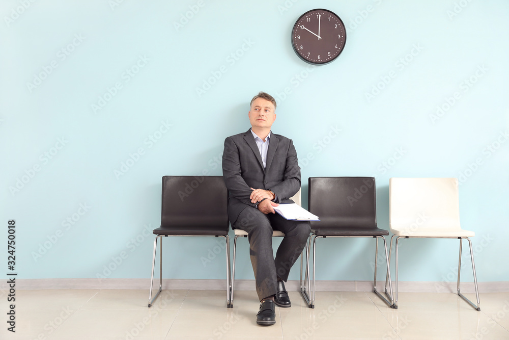 Mature man waiting for job interview indoors