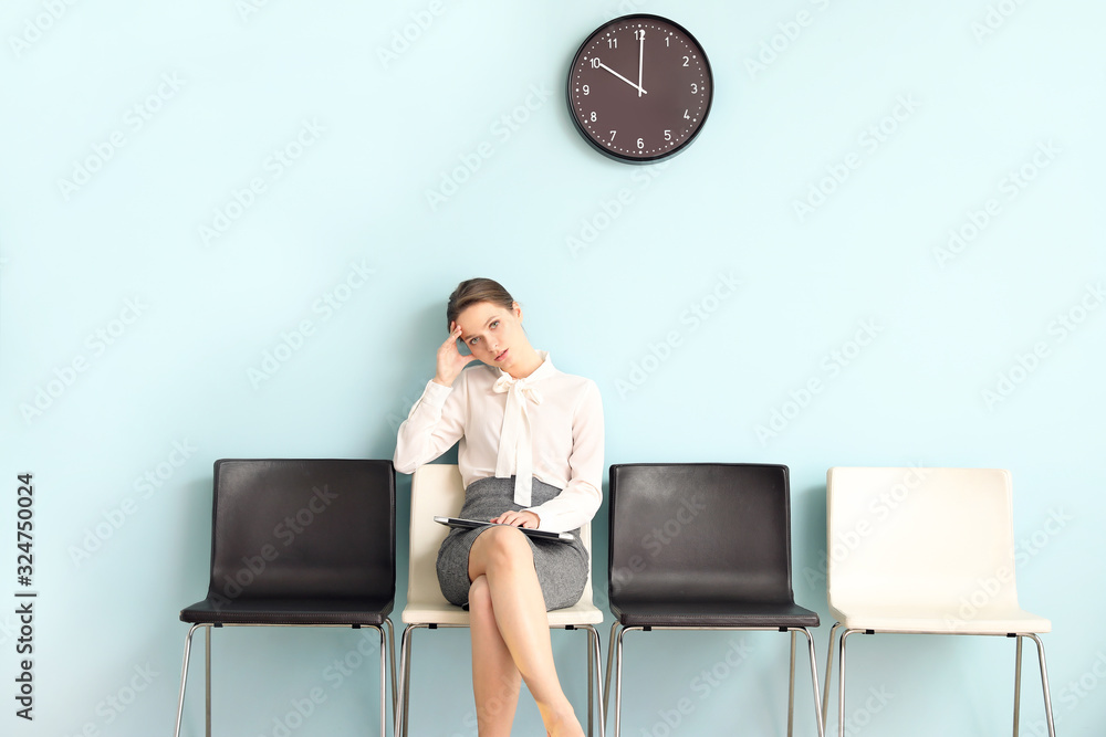 Young woman waiting for job interview indoors