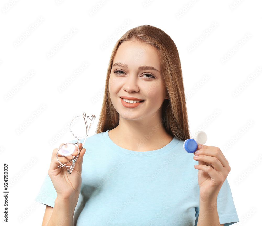 Young woman with contact lens case and eyeglasses on white background