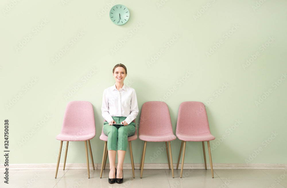 Young woman waiting for job interview indoors