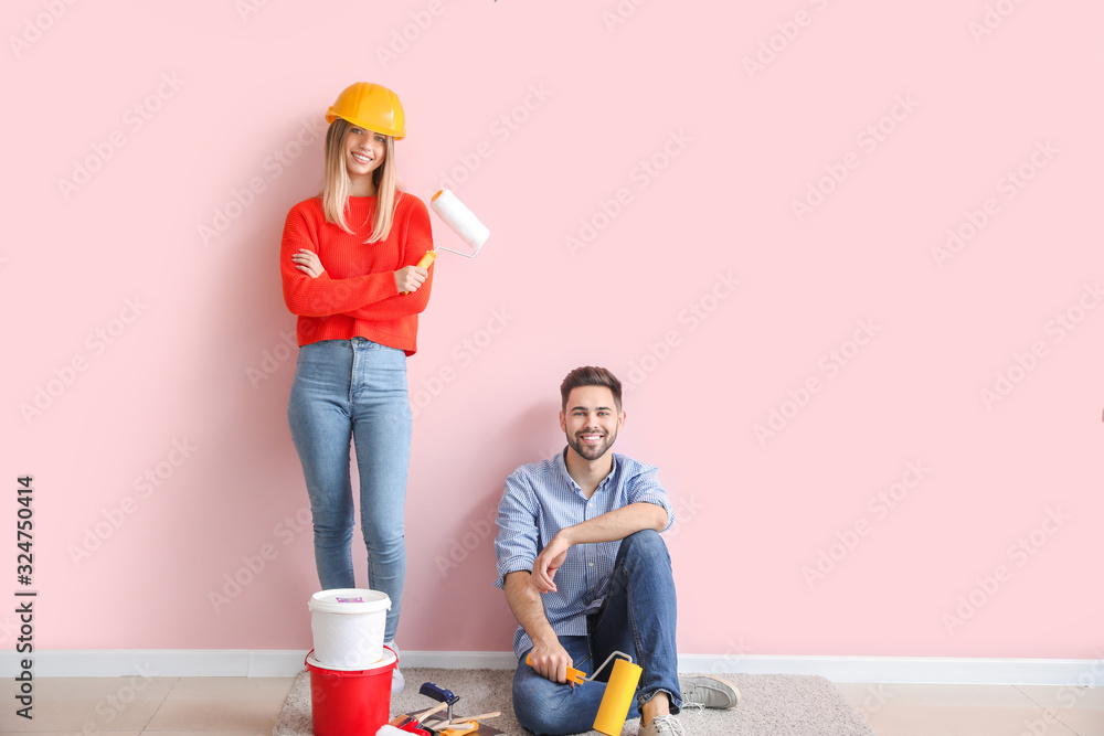 Young couple doing repair in new apartment