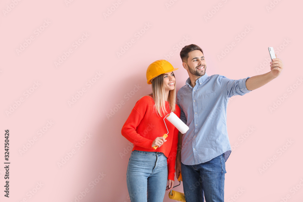 Young couple taking selfie during repair in new apartment