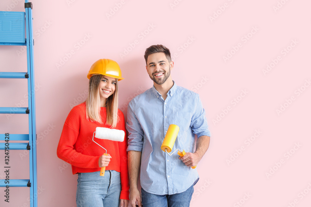 Young couple doing repair in new apartment