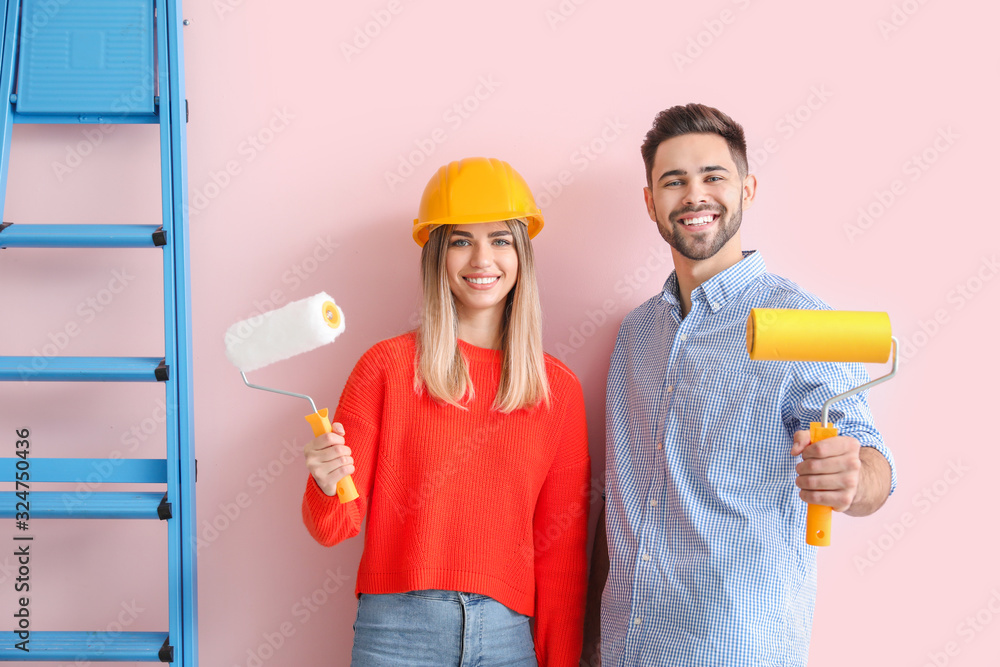 Young couple doing repair in new apartment