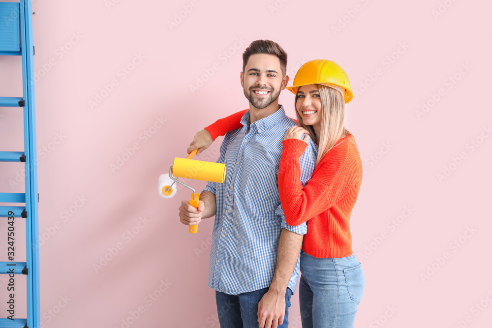 Young couple doing repair in new apartment