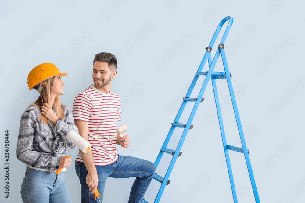 Young couple doing repair in new apartment