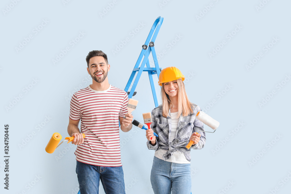 Young couple doing repair in new apartment