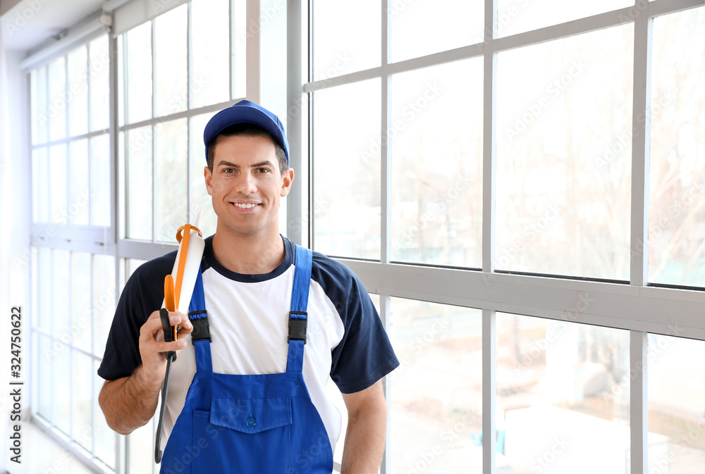 Portrait of male worker near window