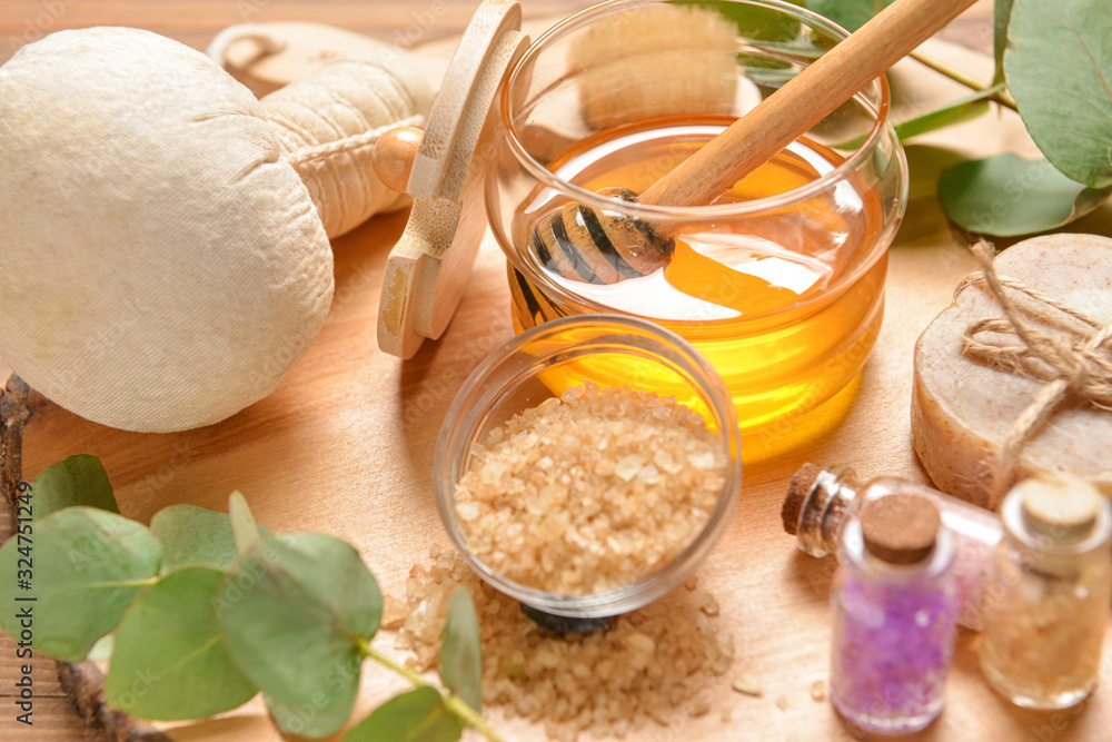 Composition with spa items and honey on wooden background