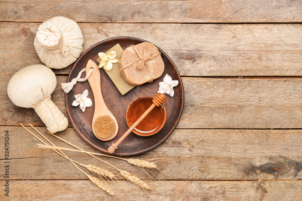 Composition with spa items and honey on wooden background